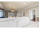 Bright kitchen with white cabinetry, island, and tiled flooring at 8923 Meadow Vista Rd, Charlotte, NC 28213