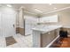 Bright kitchen featuring white cabinetry, modern appliances, and tiled flooring at 8923 Meadow Vista Rd, Charlotte, NC 28213