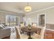 Inviting living room featuring a dining area, hardwood floors, and abundant natural light at 8923 Meadow Vista Rd, Charlotte, NC 28213