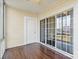 Enclosed sunroom featuring hardwood floors, light yellow walls, a ceiling fan and sliding glass doors for abundant natural light at 8923 Meadow Vista Rd, Charlotte, NC 28213