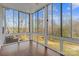 Bright sunroom enclosed with large windows offering beautiful outdoor views at 8923 Meadow Vista Rd, Charlotte, NC 28213