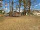 Wide open backyard with an outdoor shed and some trees at 9203 Christina Marie Ct, Charlotte, NC 28213