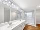 Bright bathroom featuring a double sink vanity, a walk-in shower, and white cabinets at 9203 Christina Marie Ct, Charlotte, NC 28213