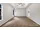 Large bedroom with vaulted ceilings, a ceiling fan and neutral carpeting at 9203 Christina Marie Ct, Charlotte, NC 28213