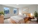 Neutral-toned staged bedroom with a large bed, soft lighting, and two bright windows at 9203 Christina Marie Ct, Charlotte, NC 28213