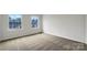 Spacious bedroom with neutral carpet, a large window view, and a bright, minimalist design at 9203 Christina Marie Ct, Charlotte, NC 28213