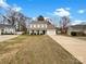 Traditional two-story home with a white exterior, a well-manicured lawn, and a sunny sky at 9203 Christina Marie Ct, Charlotte, NC 28213
