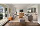 Bright, staged living room with hardwood floors, neutral-toned furniture, and large windows at 9203 Christina Marie Ct, Charlotte, NC 28213