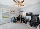 Comfortable bedroom with large window, ceiling fan, neutral walls, and a large desk setup at 1008 Hills Oak Ln, Charlotte, NC 28269
