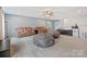 Open bonus room featuring neutral paint, plush carpeting, with ample seating options and bonus fridge at 1008 Hills Oak Ln, Charlotte, NC 28269