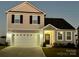 Charming two-story home features a two-car garage, a well-maintained lawn and classic architectural details at 1008 Hills Oak Ln, Charlotte, NC 28269