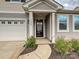 Inviting front porch with classic white columns, a black front door, and manicured landscaping at 1008 Hills Oak Ln, Charlotte, NC 28269