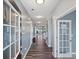 Bright hallway with wood floors, light blue walls, and white trim creating a welcoming entrance at 1008 Hills Oak Ln, Charlotte, NC 28269