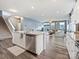 Open concept kitchen with stainless steel dishwasher and a view into the living room and backyard at 1008 Hills Oak Ln, Charlotte, NC 28269