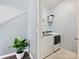 Bright laundry room with a front-loading washer and dryer on ceramic tile flooring at 1008 Hills Oak Ln, Charlotte, NC 28269