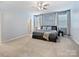 Spacious main bedroom with a ceiling fan, large windows, and light blue accent wall at 1008 Hills Oak Ln, Charlotte, NC 28269