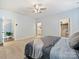 Bright main bedroom with a ceiling fan, open doorways, and plush carpeting at 1008 Hills Oak Ln, Charlotte, NC 28269