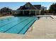 Community pool area with a pool house, featuring a refreshing pool, lounge chairs, and well-maintained surroundings at 1008 Hills Oak Ln, Charlotte, NC 28269