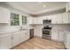 Modern kitchen featuring white cabinets, stainless steel appliances, and ample counter space at 1009 W 3Rd Ave, Gastonia, NC 28052