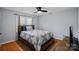 Serene bedroom featuring hardwood floors, a cozy bed, and natural light for a relaxing ambiance at 106 Biltmore Ave, China Grove, NC 28023