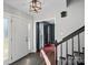 Welcoming foyer with hardwood floors, stylish light fixture, and staircase leading to the upper level at 106 Biltmore Ave, China Grove, NC 28023