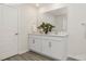 Bright bathroom features a double sink vanity with white cabinetry, large mirror and modern fixtures at 11217 Cardinal Creek Ave, Charlotte, NC 28215