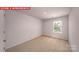 Bright bedroom features neutral carpet, white walls, and a window overlooking the green yard at 11217 Cardinal Creek Ave, Charlotte, NC 28215