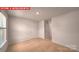 Bright bedroom features neutral carpet, white walls, and two interior doors at 11217 Cardinal Creek Ave, Charlotte, NC 28215