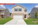 New two-story home with a two-car garage, brick accents, and a well-manicured lawn at 11217 Cardinal Creek Ave, Charlotte, NC 28215