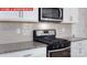Close up of kitchen with white cabinets, granite countertops, and stainless steel appliances at 11217 Cardinal Creek Ave, Charlotte, NC 28215