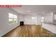 Living room showcasing fireplace, wood floors, and natural light from large windows at 11217 Cardinal Creek Ave, Charlotte, NC 28215