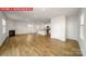 Open-concept living space with fireplace, wood-look flooring, and views into the kitchen at 11217 Cardinal Creek Ave, Charlotte, NC 28215