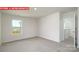 Comfortable bedroom with soft carpeting, a large window, and a view of the outdoors at 11225 Cardinal Creek Ave, Charlotte, NC 28215