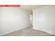 Neutral-toned bedroom featuring plush carpet and a crisp white door at 11225 Cardinal Creek Ave, Charlotte, NC 28215