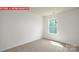 This bright bedroom is enhanced by natural light and neutral carpeting at 11225 Cardinal Creek Ave, Charlotte, NC 28215