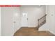 Inviting entryway featuring wood-look flooring, stairs and a craftsman-style front door with glass panels at 11225 Cardinal Creek Ave, Charlotte, NC 28215