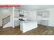 Modern kitchen boasting an island with granite countertops, stainless steel appliances, and ample cabinet space at 11225 Cardinal Creek Ave, Charlotte, NC 28215