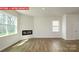 Spacious living room featuring hardwood floors, a modern fireplace, and ample natural light at 11225 Cardinal Creek Ave, Charlotte, NC 28215