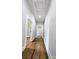 Hallway with hardwood floors, neutral paint, and white trim at 113 Brawley St, Chester, SC 29706