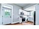 Bright kitchen featuring white cabinets, stainless steel appliances and a door to the outside at 113 Brawley St, Chester, SC 29706