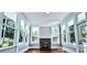 Sunroom features beautiful wood flooring, lots of natural light, and a brick fireplace at 113 Brawley St, Chester, SC 29706