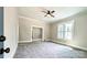 Spacious carpeted living room with classic trim work, a fan, and lots of light at 113 Brawley St, Chester, SC 29706