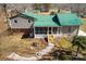 Aerial view of a cozy home with a green metal roof and a screened porch at 121 Alexis Forest Dr, Stanley, NC 28164