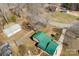 An aerial perspective reveals the home, surrounded by mature trees and featuring a green roof and a separate garage at 121 Alexis Forest Dr, Stanley, NC 28164