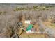 Aerial view of the property showcasing its wooded surroundings, the structures and their proximity to each other at 121 Alexis Forest Dr, Stanley, NC 28164