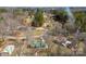 Aerial view of the property showcasing its wooded surroundings, the structures and their proximity to each other at 121 Alexis Forest Dr, Stanley, NC 28164