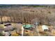 Aerial view of the property showcasing its spacious lot, multiple structures, and wooded surroundings at 121 Alexis Forest Dr, Stanley, NC 28164