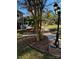 View of the landscaped backyard with a stone walkway and mature trees at 121 Alexis Forest Dr, Stanley, NC 28164