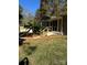 A beautiful screened-in porch with steps leads to a manicured lawn and tropical foliage for outdoor enjoyment at 121 Alexis Forest Dr, Stanley, NC 28164