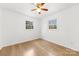 An airy bedroom with hardwood floors, two windows and a ceiling fan at 121 Alexis Forest Dr, Stanley, NC 28164